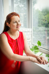 Portrait of a beautiful pregnant woman in the room near the window