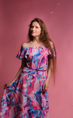 Obraz na płótnie Canvas portrait of pretty woman in pink dress