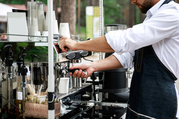Barista making coffee using professional espresso machine