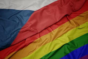 waving colorful gay rainbow flag and national flag of czech republic.