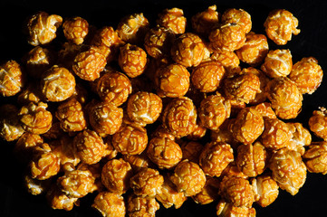 sweet Caramel Cream popcorn on the black background
