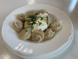 Homemade meat dumplings - russian pelmeni. Dumplings, filled with meat, ravioli. Dumplings with filling.