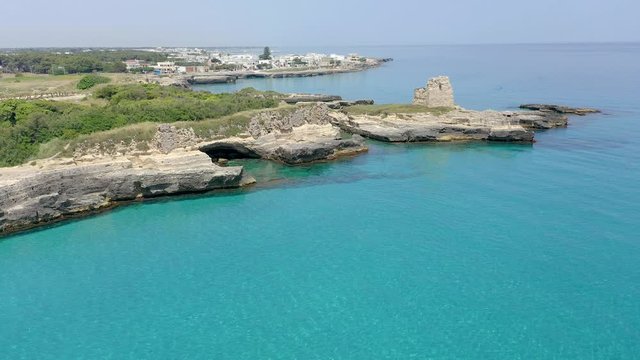 Aerial view, flight at Tower and bay of Roca Vecchia (Torre di Maradico), archaeological sites, Brindisi region, Apulia Italy