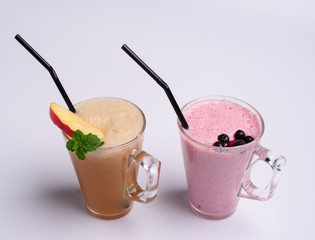Glass of pink strawberry milkshake or cocktail isolated on white background.