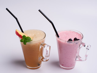 Glass of pink strawberry milkshake or cocktail isolated on white background.