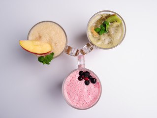 Glass of pink strawberry milkshake or cocktail isolated on white background.