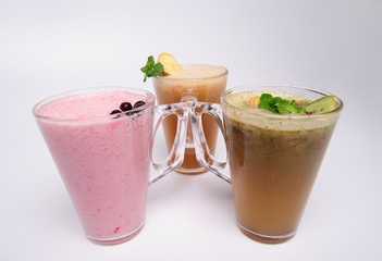 Glass of pink strawberry milkshake or cocktail isolated on white background.