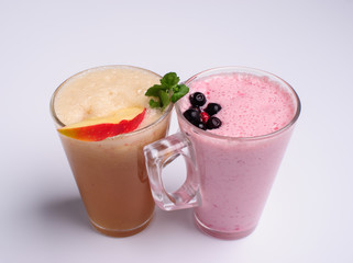 Glass of pink strawberry milkshake or cocktail isolated on white background.