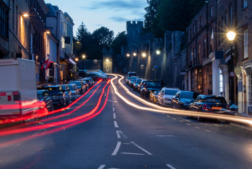 Arundel High Street, West Sussex, night photo with car light trails. Arundel is a popular tourist attraction with a beautiful castle and impressive cathedral.