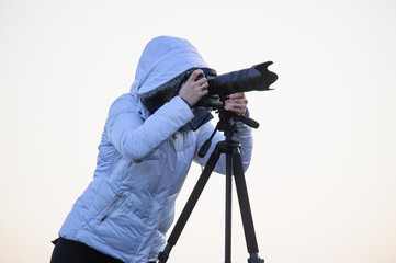 photographer with camera and tripod outdoor taking landscape picture