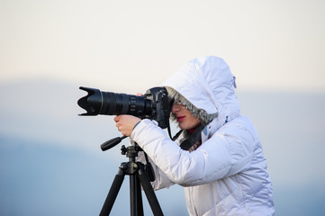 photographer with camera and tripod outdoor taking landscape picture