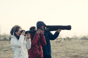 Funny picture! Photographers with cameras and tripod making outdoor landscape picture