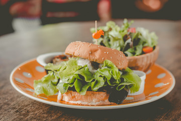 Home-made tofu burger carefully made of tofu and onion teriyaki sauce.small pan fried shredded potato and small salad and pumpkin soup