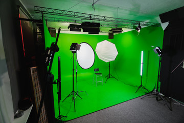 Fototapeta na wymiar Interior of Modern Film Chroma Key Studio with Green Screen and Light Equipment
