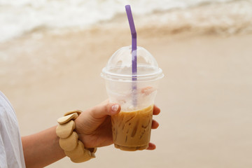 Iced coffee drink in female hand
