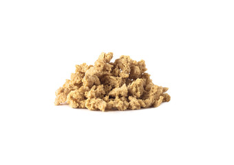 Side view of textured vegetable protein or soy meat chunks heap isolated on white background