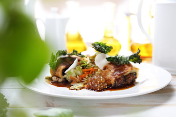 Vegetarian cooking. Vegetable cutlet stuffed with spinach, sun-dried tomatoes, marinated turnip, kimchi salad, bean puree, kale chips and mushroom tapioca