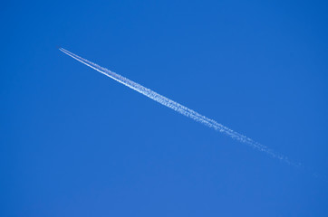 airplane contrail in the blue sky