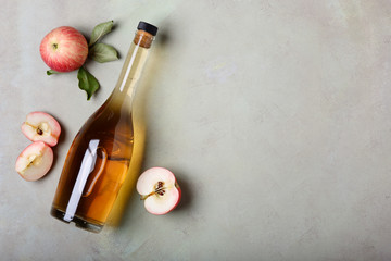 Apple cider vinegar and fresh apples, flat lay, space for your text