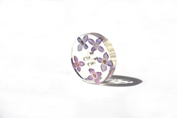 Beautiful floral button, epoxy resin flowers of lilac.