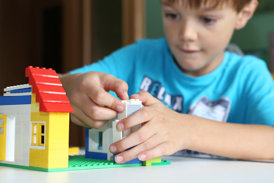 Junge baut mit Bausteinen ein Haus