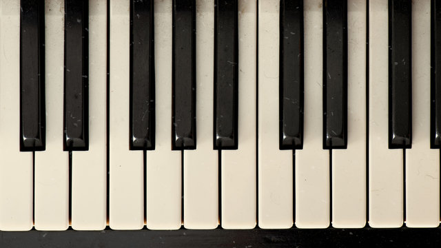 Close-up of a dirty old vintage effect piano keyboard