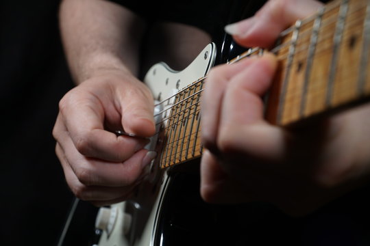 Guitar player on black background