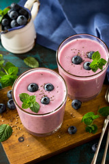 Healthy Chia seed pudding in a glass with blueberry on slate table. Healthy breakfast, vitamin snack, diet and healthy eating.