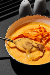 Close-up shot of a delicious cream soup with meat, top view.