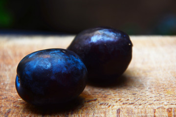 plums on wooden table
