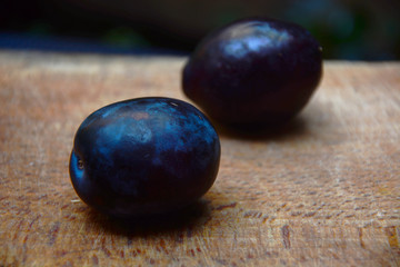 plums on wooden table