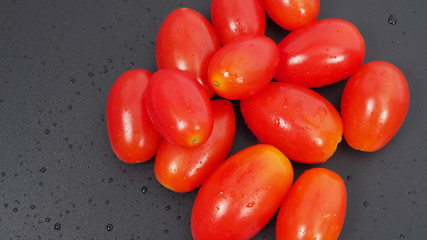 Close up group of Cherry Tomatoes on black background.