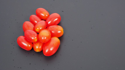 Close up group of Cherry Tomatoes on black background.