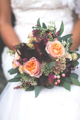 close up of a bouquet of flowers in the hands of the bride