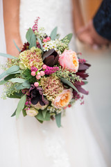 close up of a bouquet of flowers in the hands of the bride