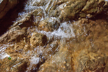 Creek river water flowing on stones