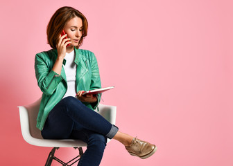 Young woman studying whith notepad in a chair