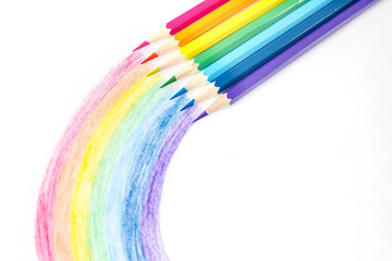 Color pencils with rainbow drawing isolated on white background. Top view.