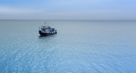 view of a small lonely ship sailing on Lake Baikal