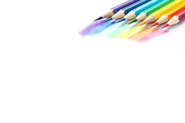 Color pencils with rainbow drawing isolated on white background. Top view.