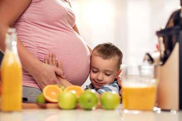 Mother and her  son  making juice together