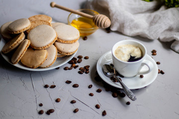 poured aromatic coffee into a white cup and saucer, laid coffee beans next to me, and dotted the background with flowers. Appetizingly look pastries bisé.