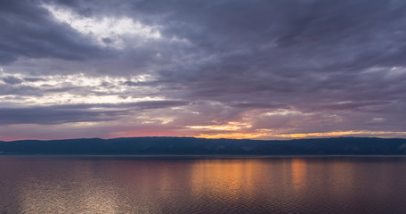 Naklejka na ściany i meble view of the gorgeous sunset from the island of Olkhon on Lake Baikal