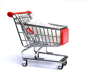 Shopping cart with receipt isolated on white background. Concept of grocery expenses and consumerism.