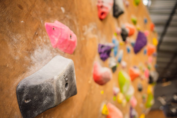 Wooden wall with climbing holds in gym