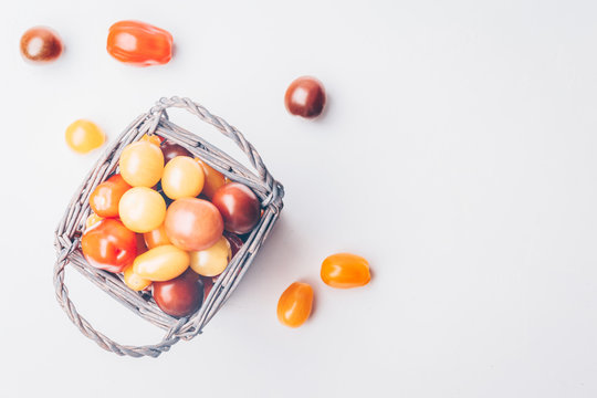 Heirloom cherry tomatoes on the white concrete background