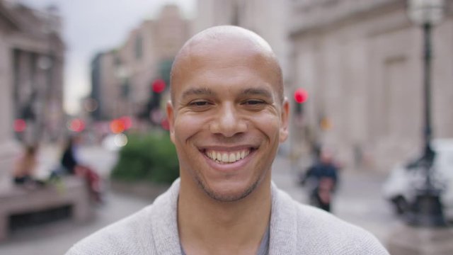 Portrait of attractive mixed race male smiling to camera in the city