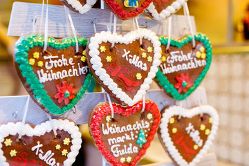 Gingerbread Hearts at German Christmas Market. Nuremberg, Munich, Fulda, Berlin, Hamburg xmas market in Germany. In German language Merry Christmas.