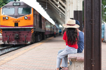 child is waiting for the train at train station