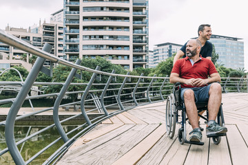 man in wheelchair converses with his friend